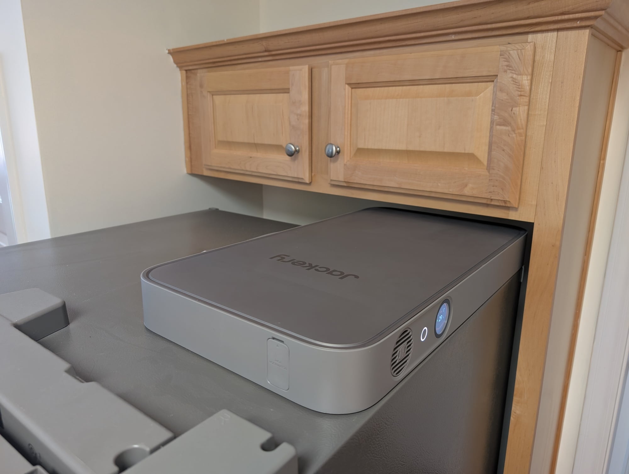 the Jackery FridgeGuard on top of a refrigerator