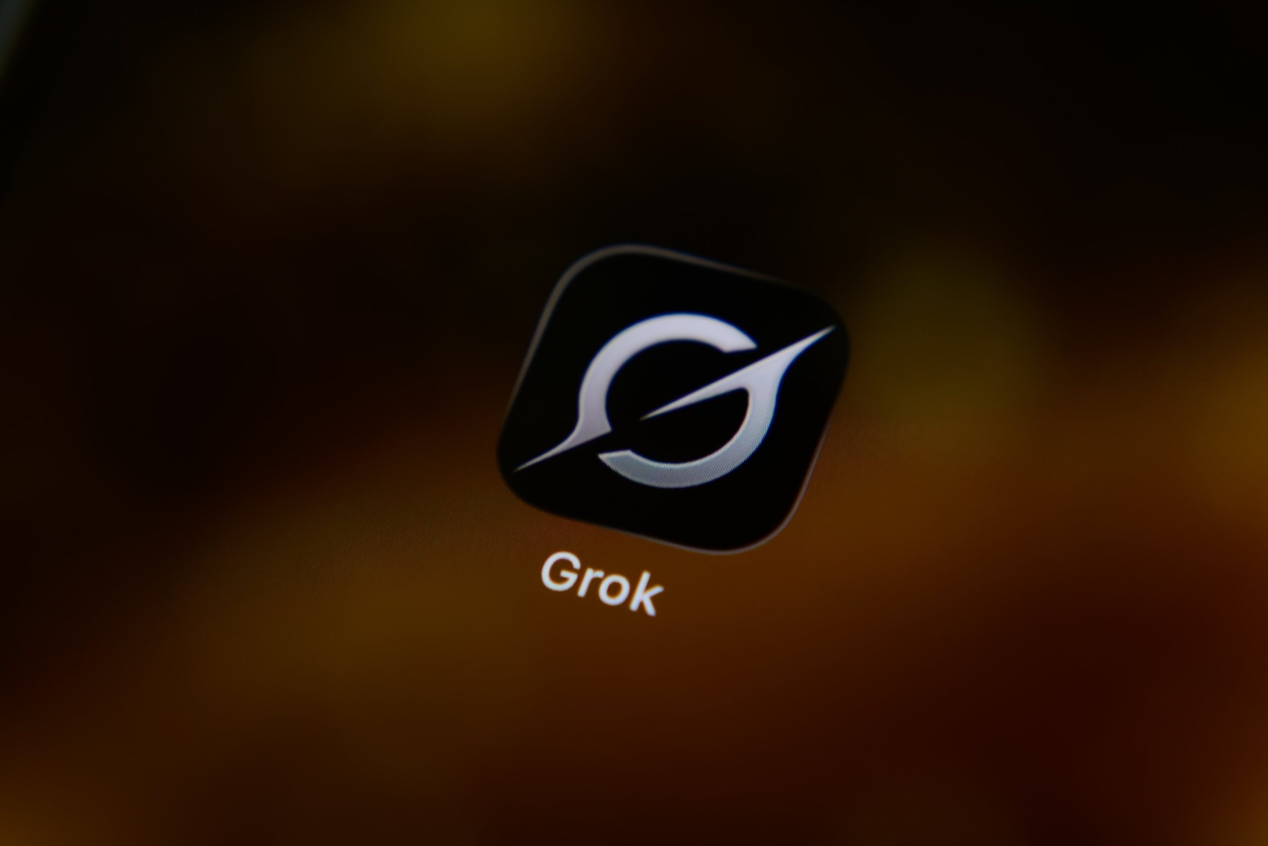 The icon for the Grok artificial intelligence app is displayed on a smartphone screen