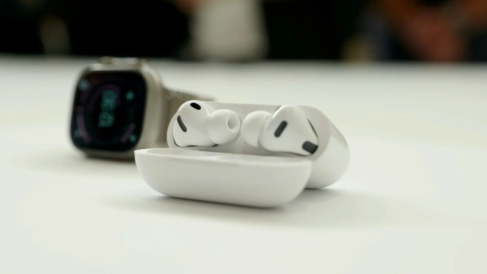 apple airpods on display next to apple watch