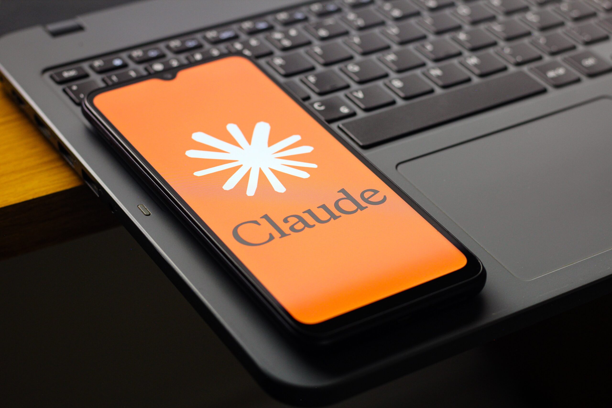  the Claude AI logo is seen displayed on a smartphone screen
