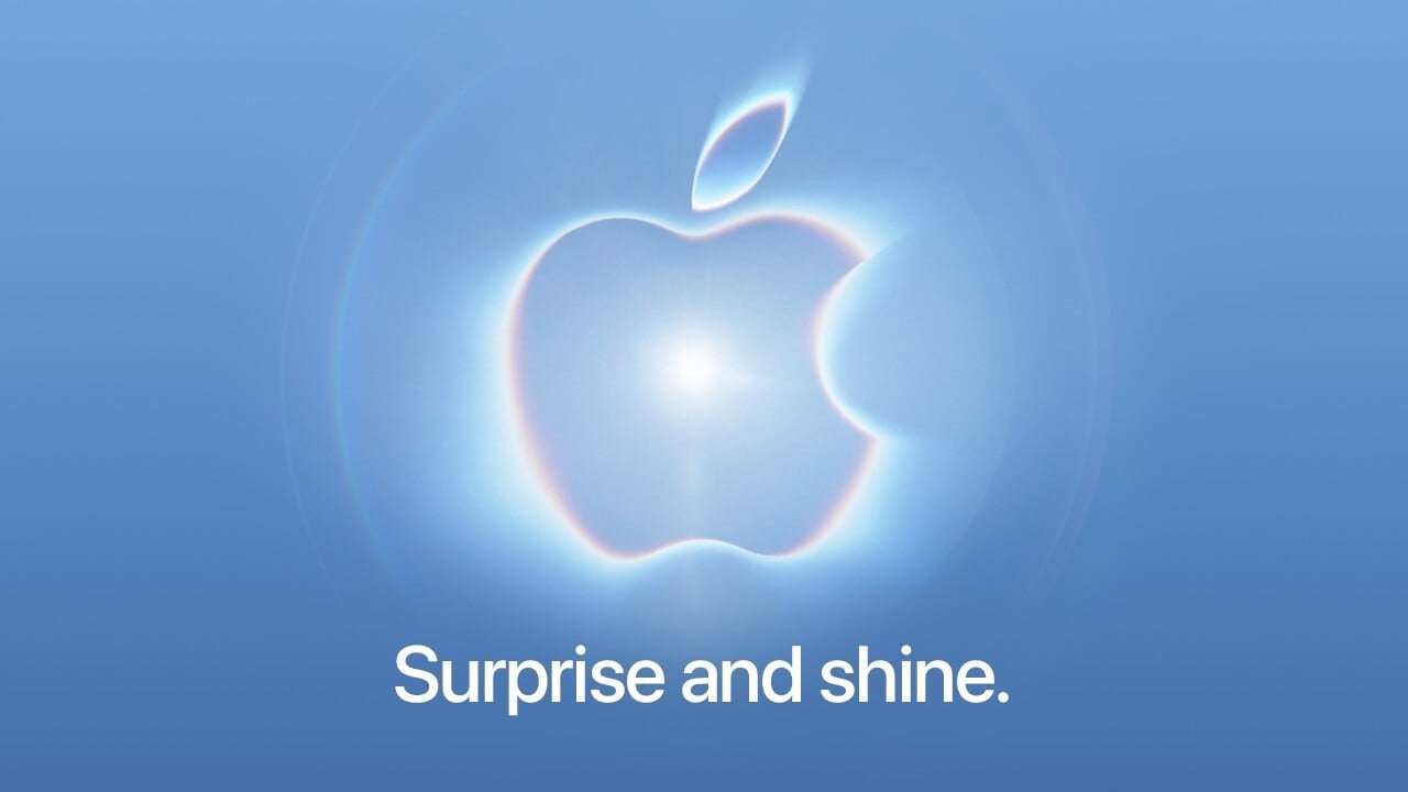 Apple logo with a glowing neon effect in blue and pink hues, a bright white flare at its center, on a gradient background and text that reads 'surprise and shine'