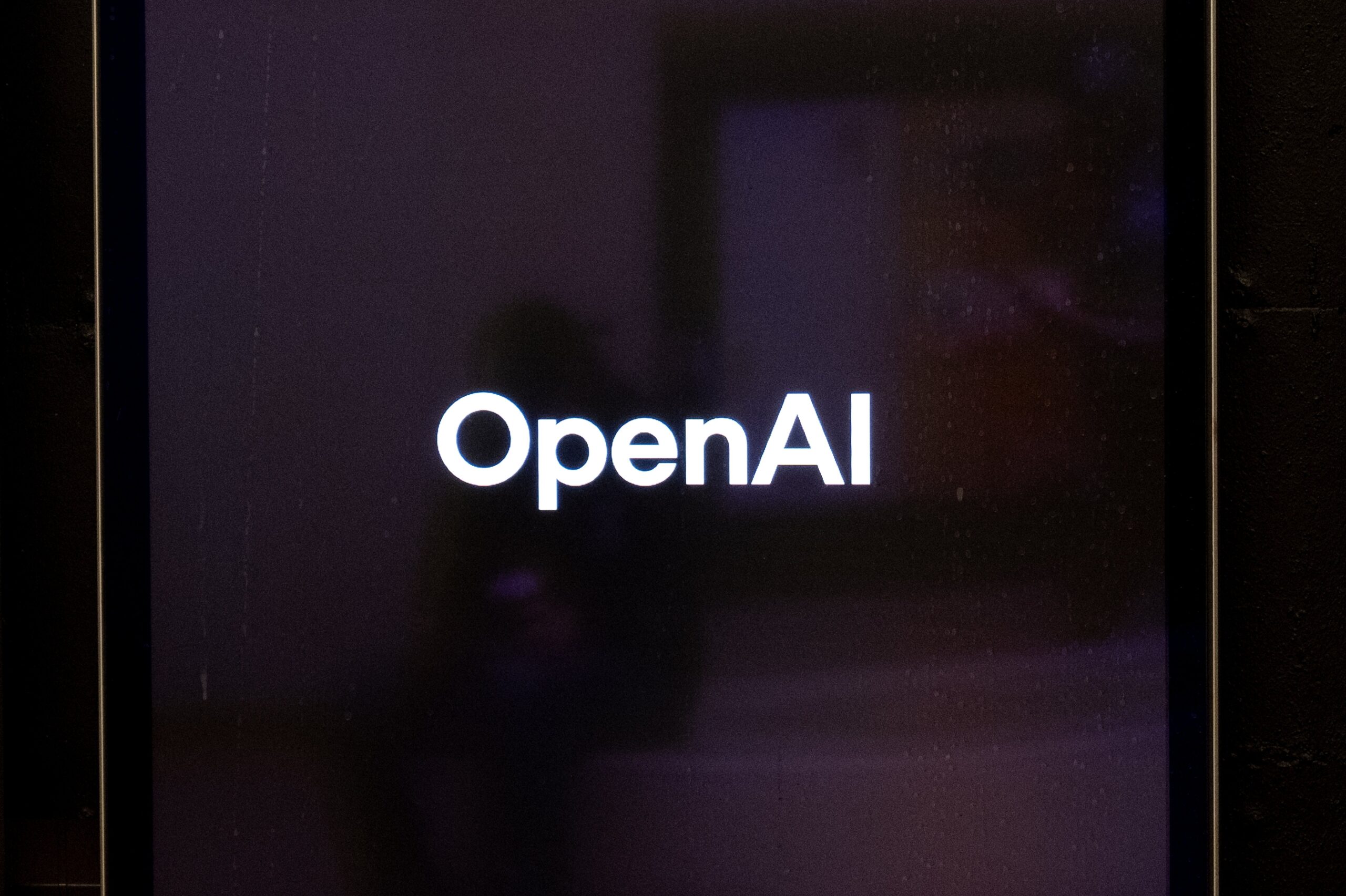 OpenAI wordmark displayed on a digital screen