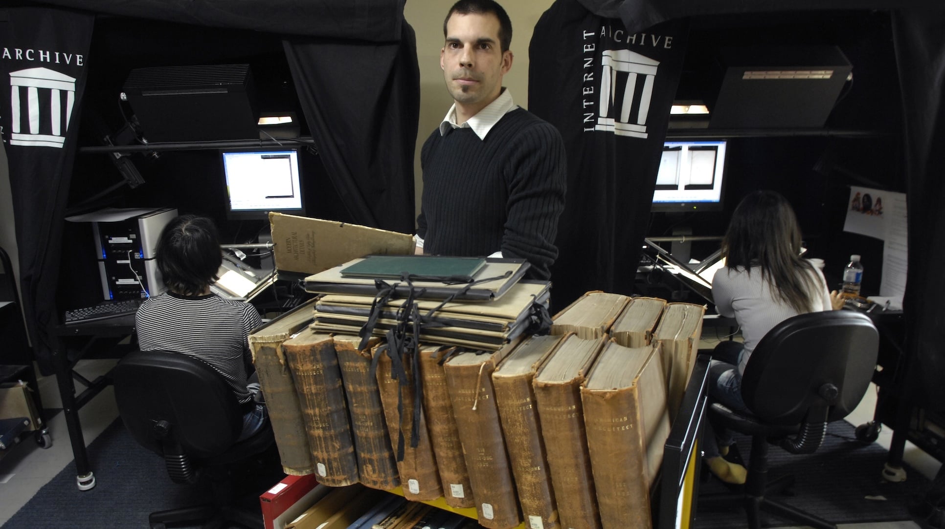 Old books being scanned by human employees in the Internet Archive