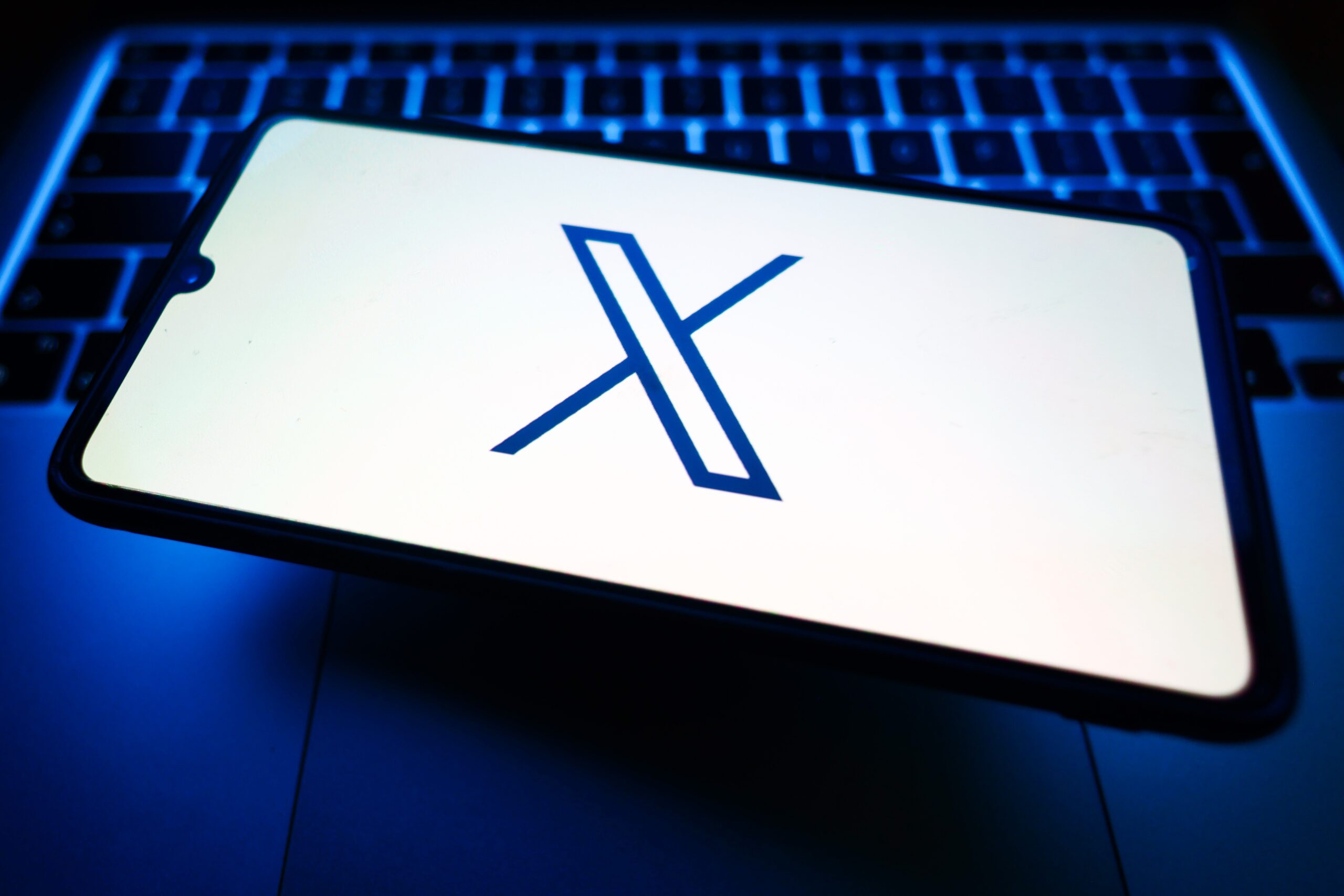 X, former Twitter, logo is displayed on a mobile phone screen for illustration photo