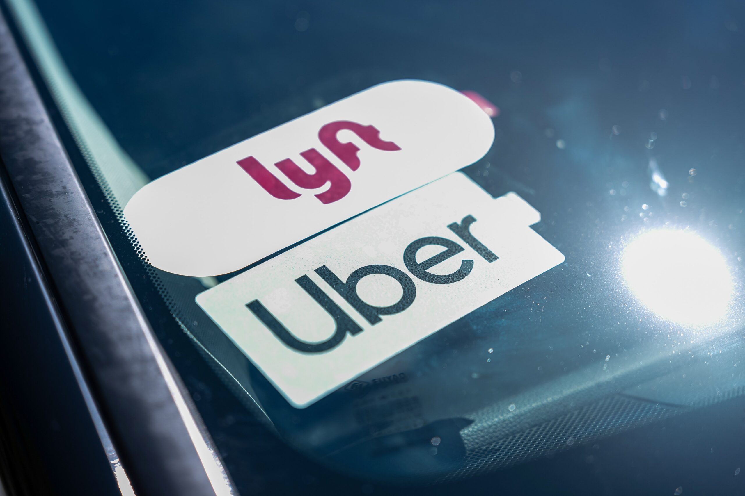 Uber and Lyft signage on a vehicle