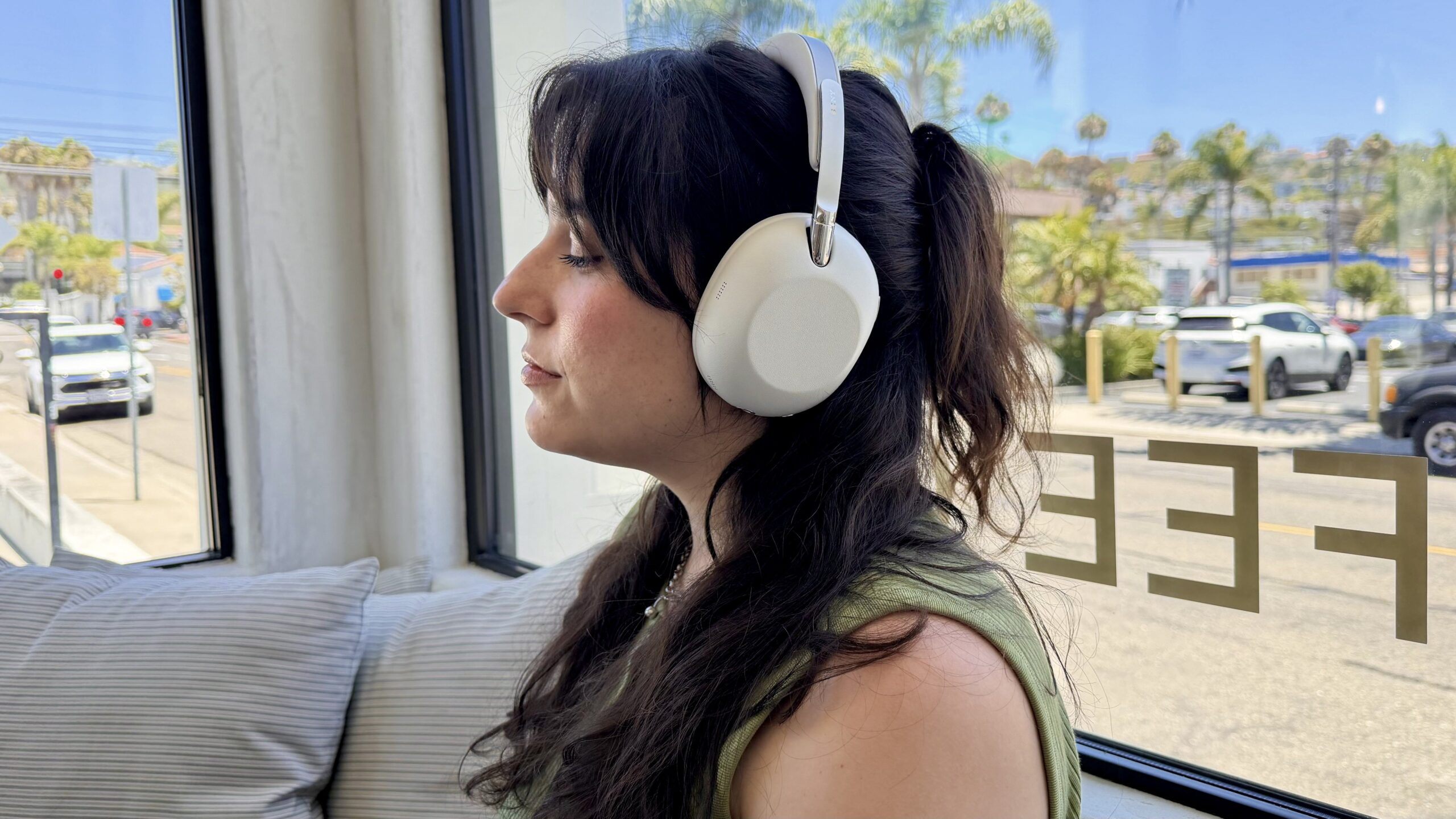 woman sitting in coffee shop wearing sony collexion headphones