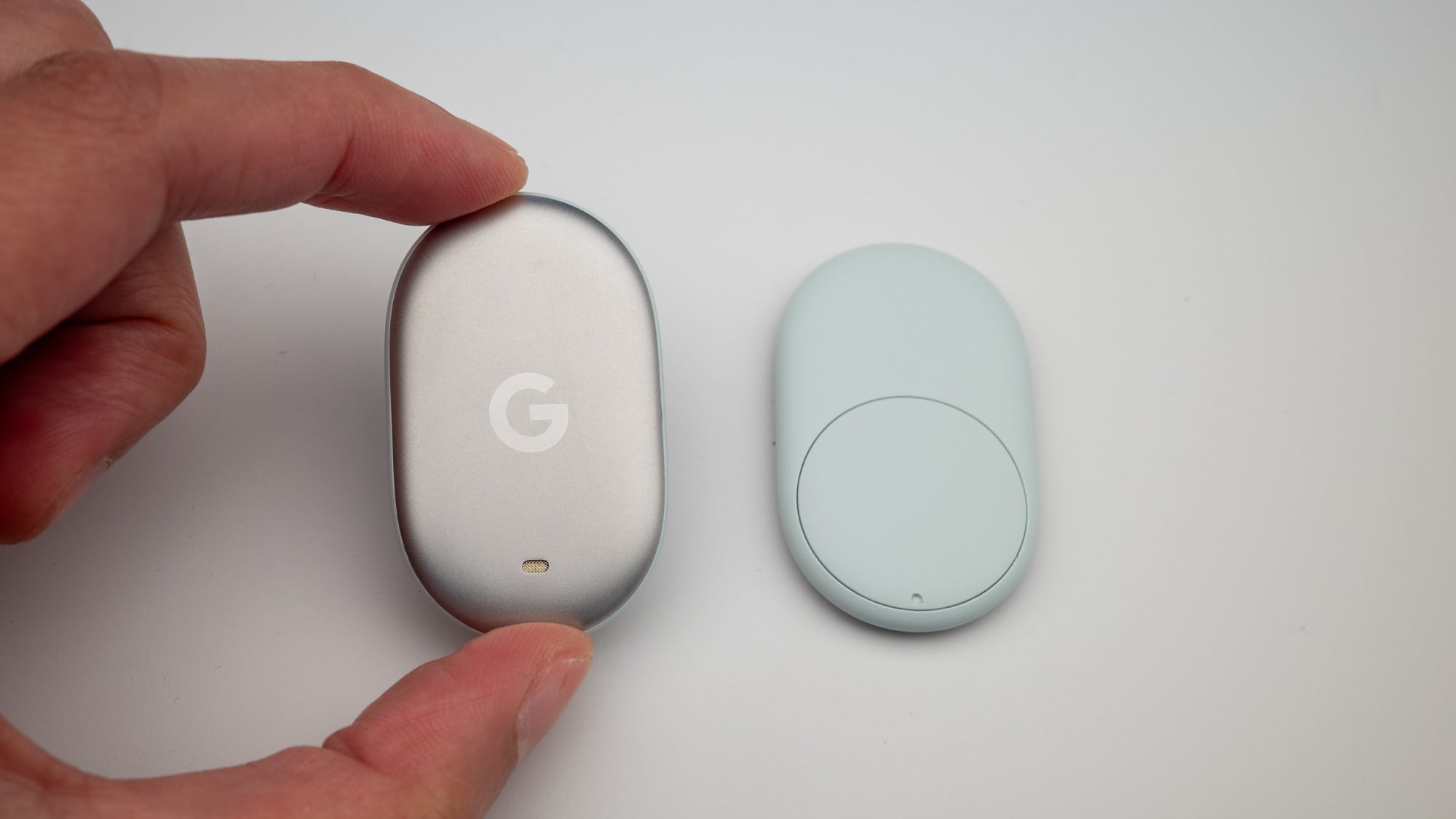 a close-up of a person holding the google pixel tag