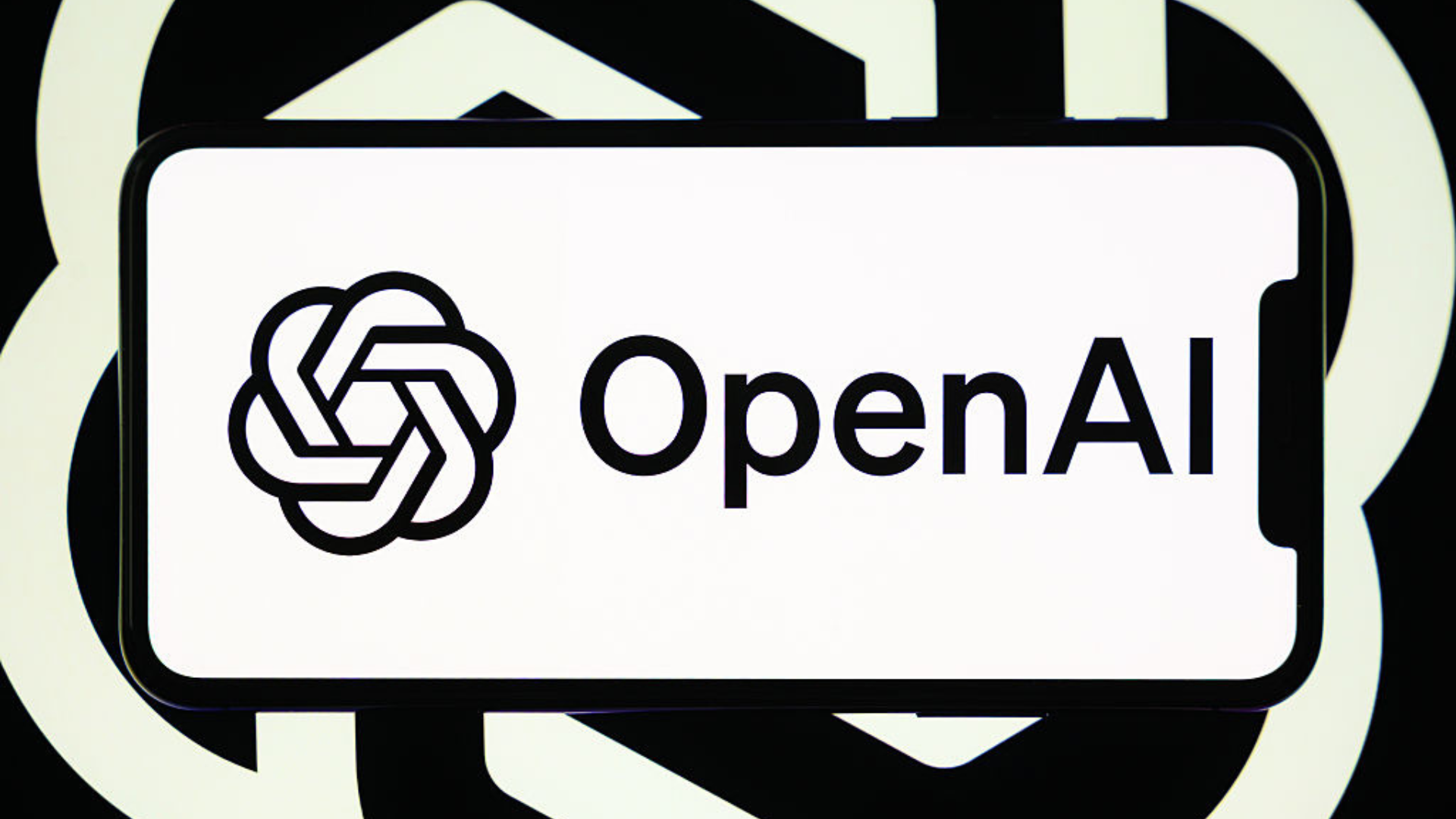 The OpenAI logo is displayed on a smartphone screen.