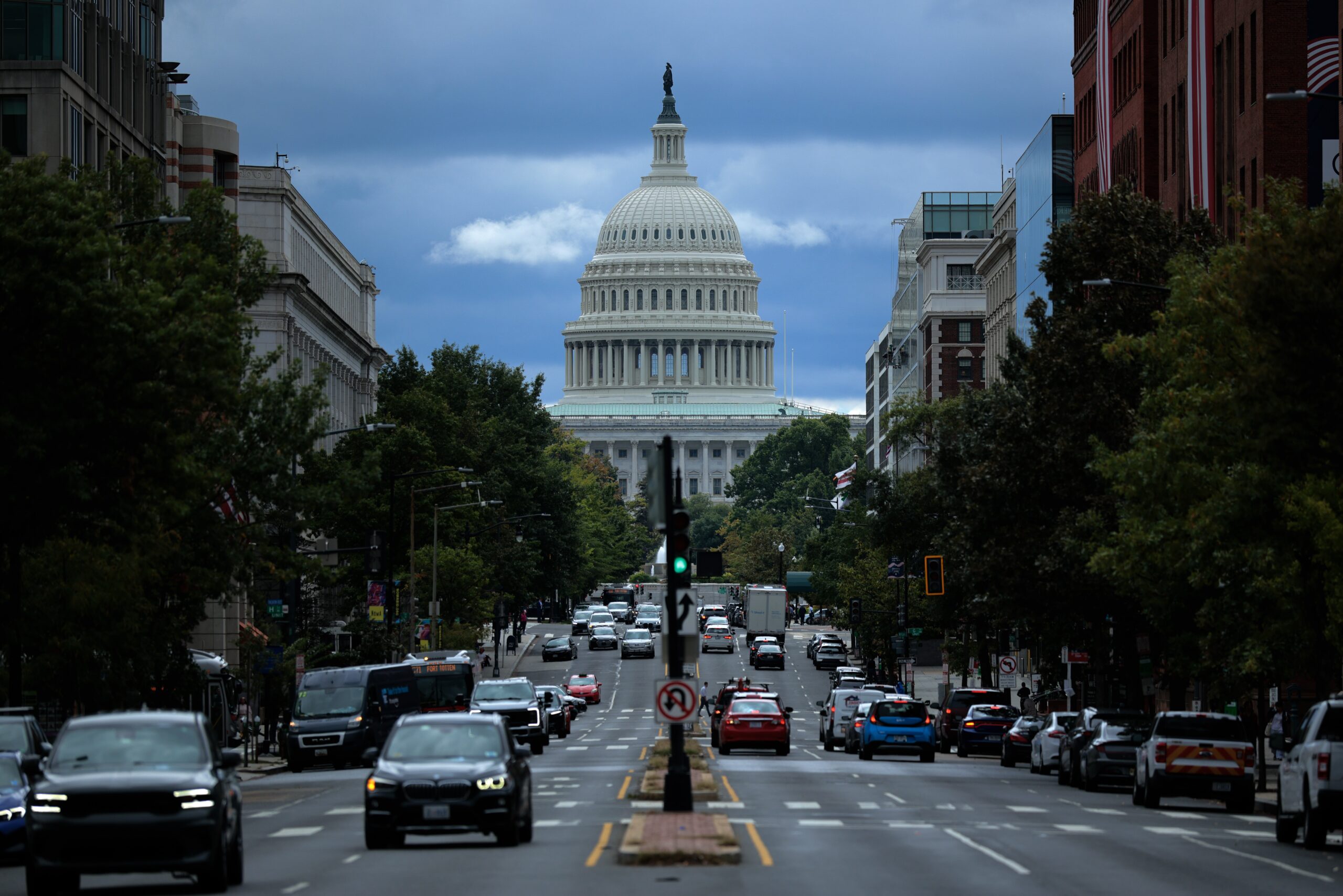 A view of the Capitol building behind a busy D.C. street.