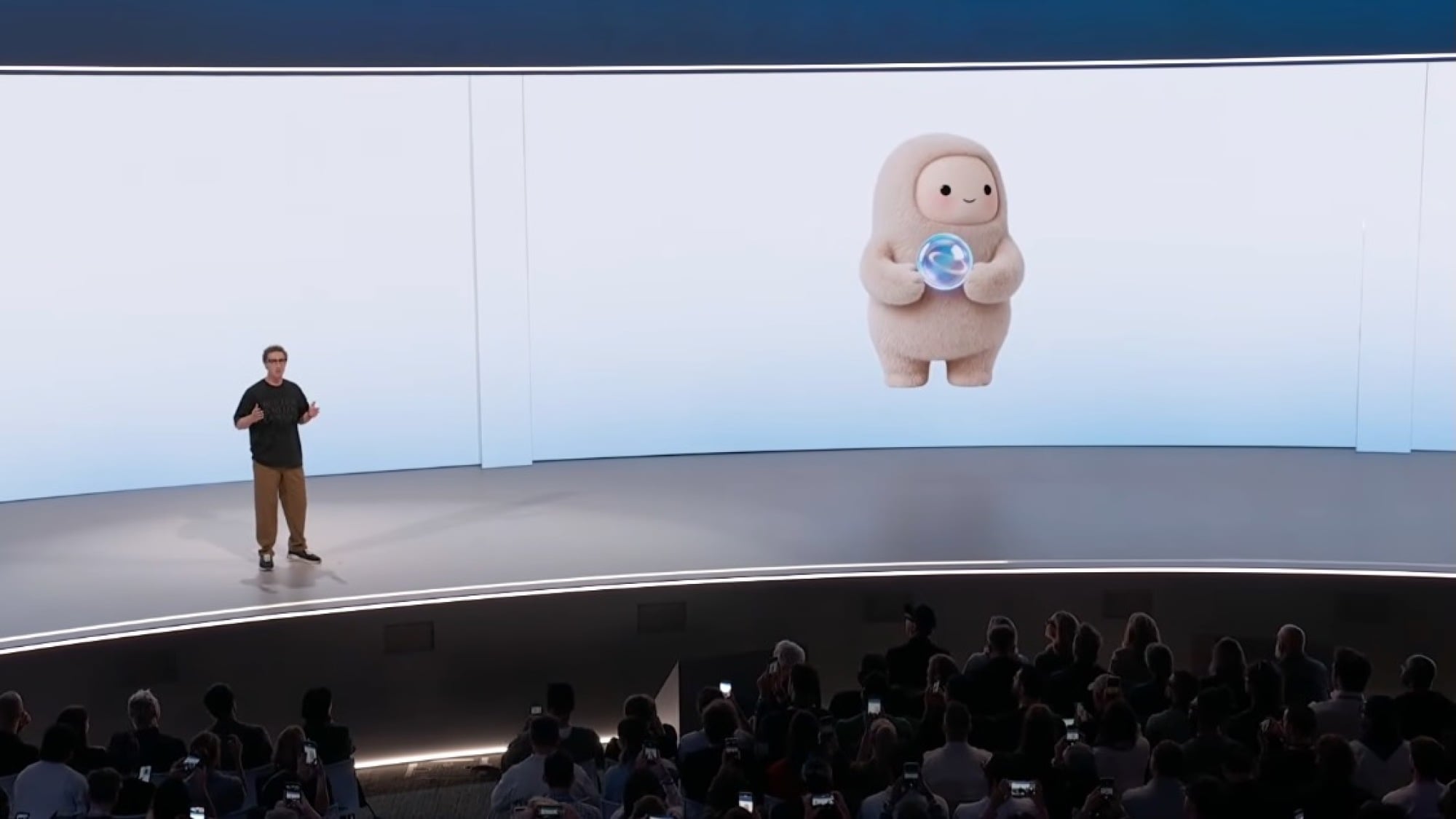 mark zuckerberg on stage with the muse mascot jolly