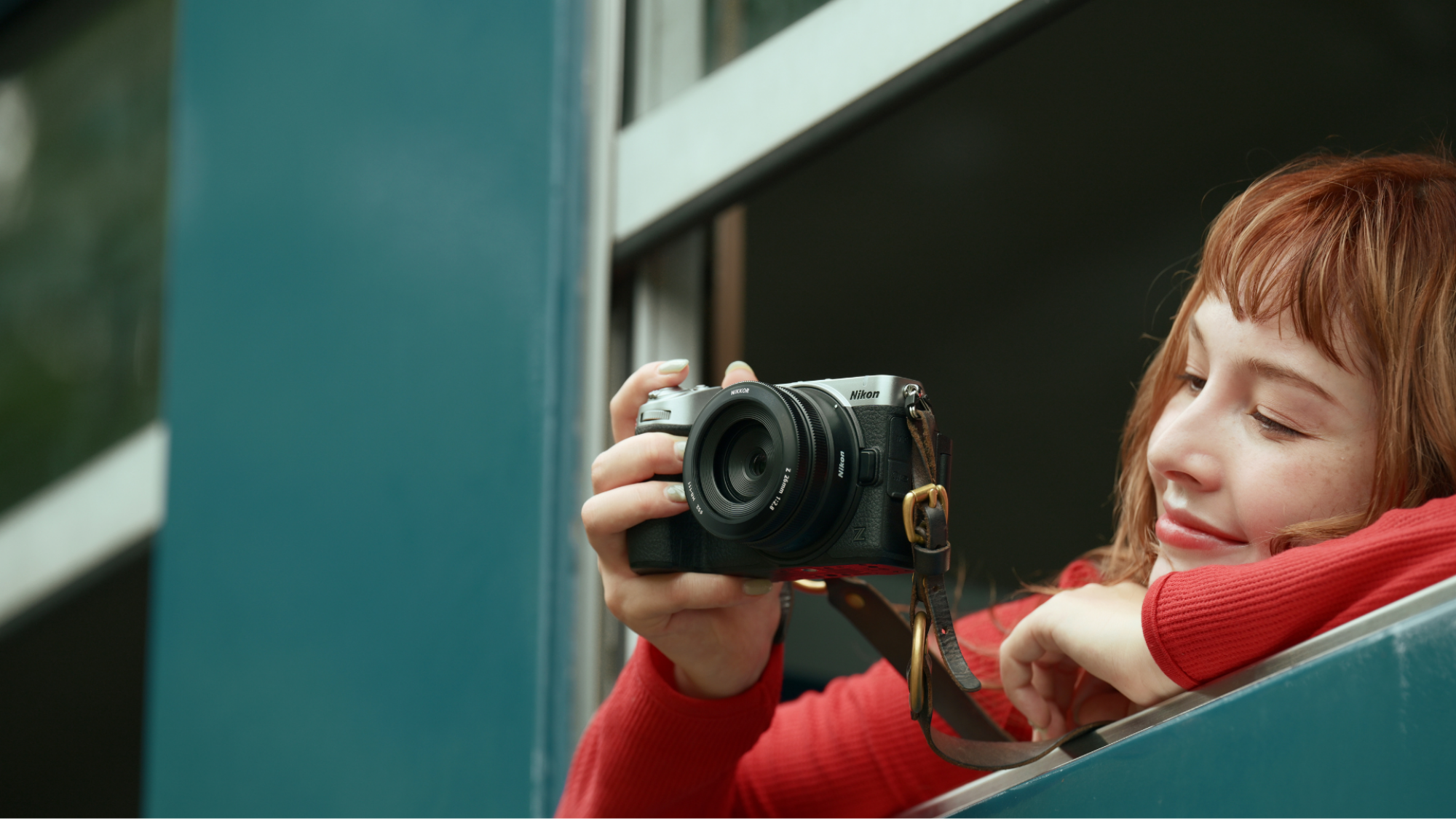 A woman holding the Nikon Z5IIC.