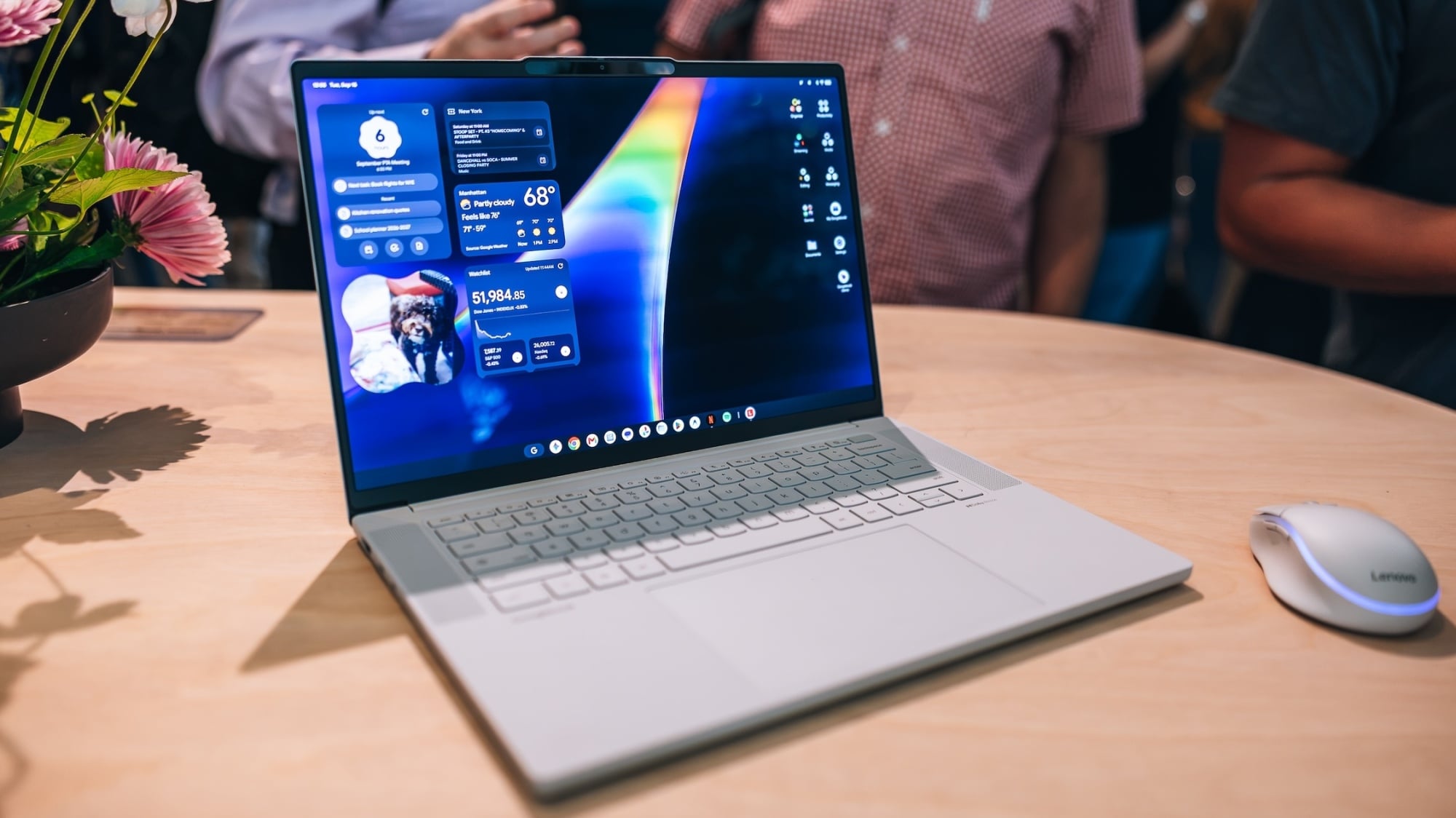 the lenovo Googlebook laptop on a desk surrounded by a crowd