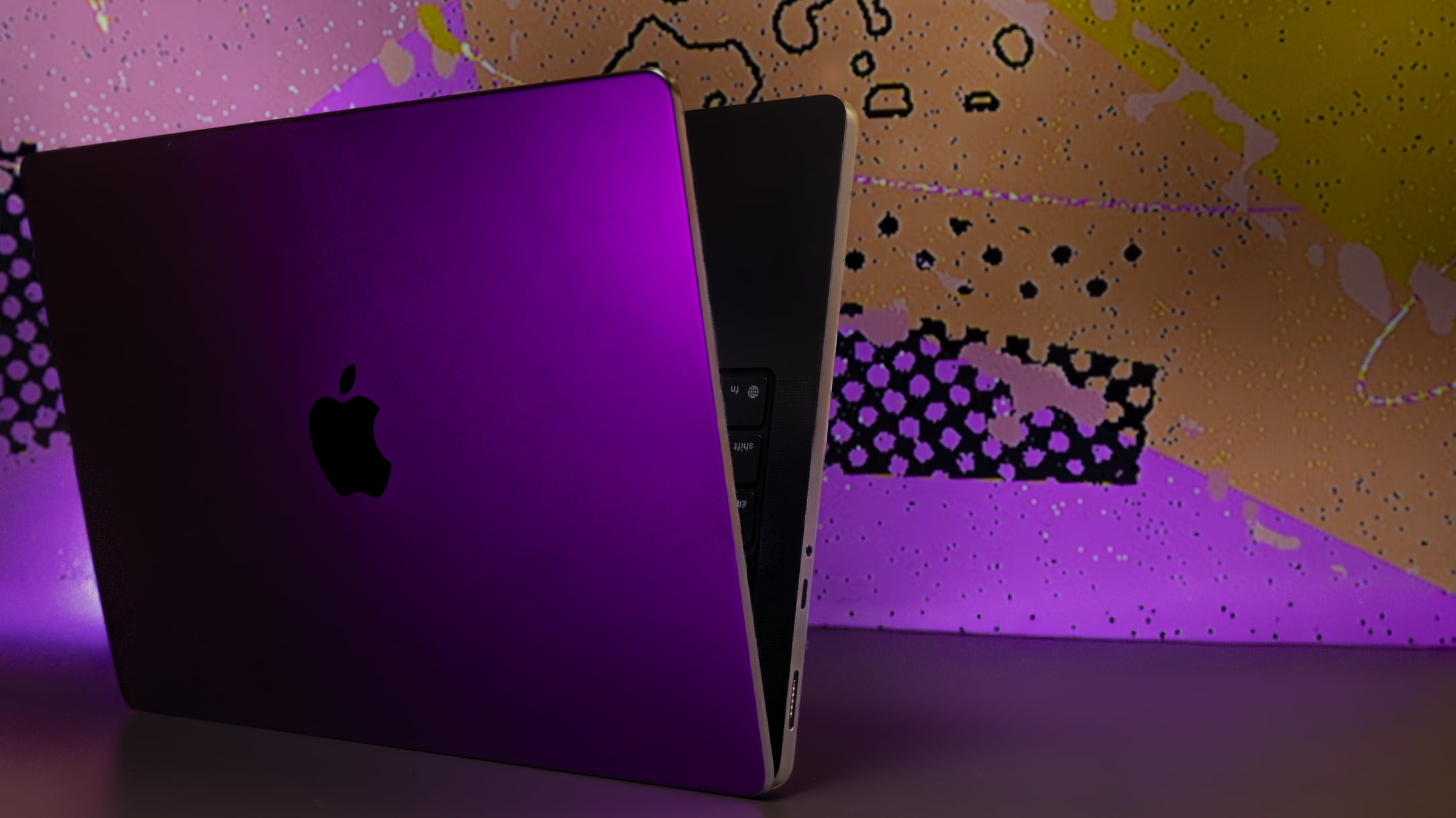m5 macbook pro in midnight black standing up on side