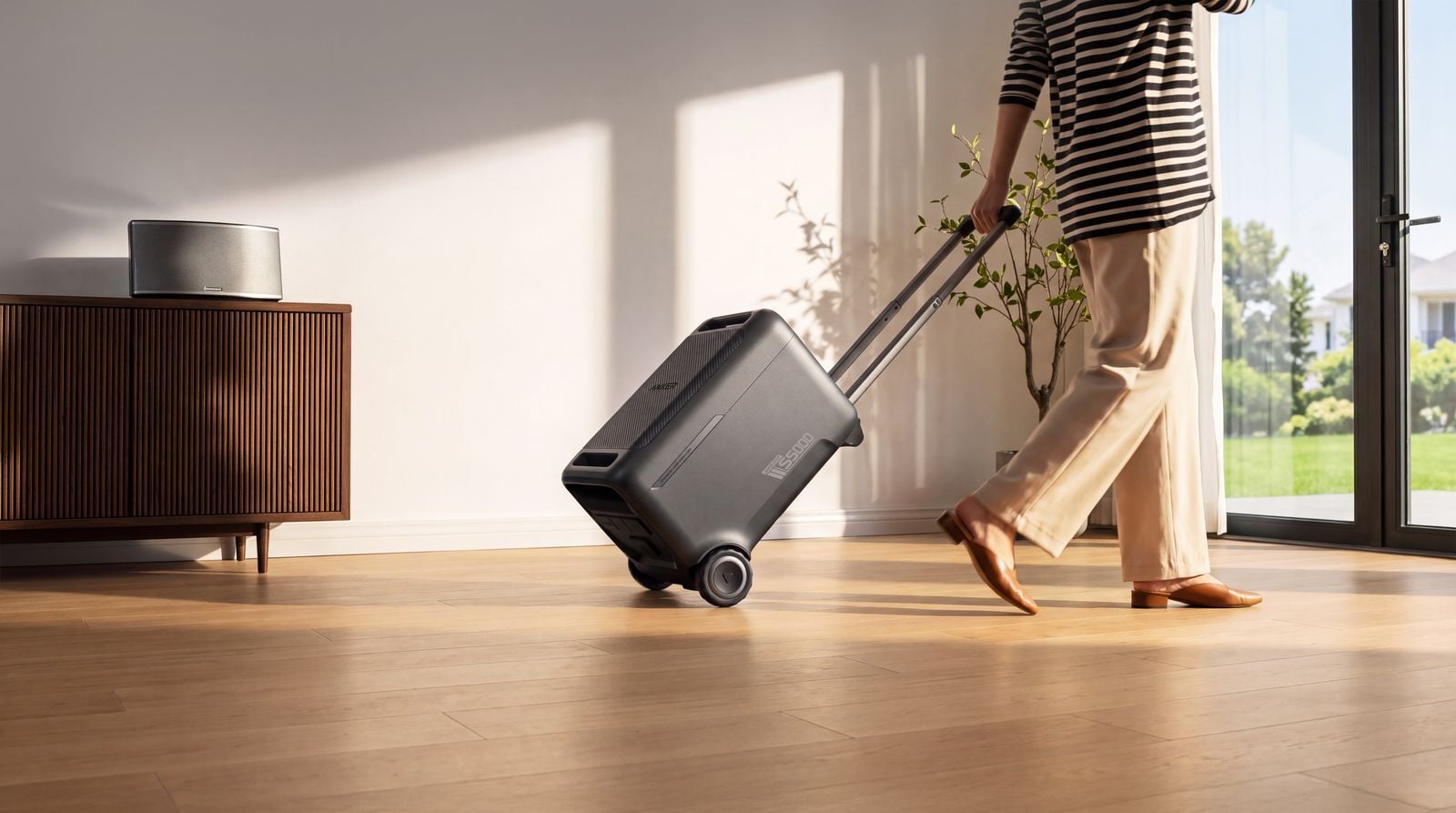 a person wheels the Anker solix s5000 behind them while walking in a bright home