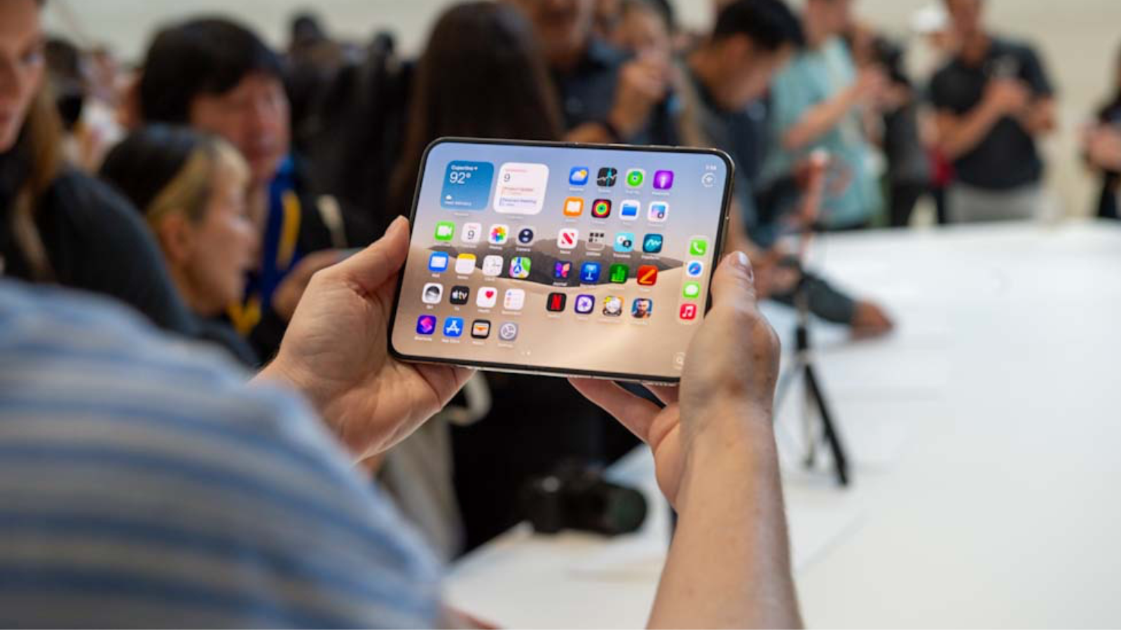 a man holding the apple iphone duo