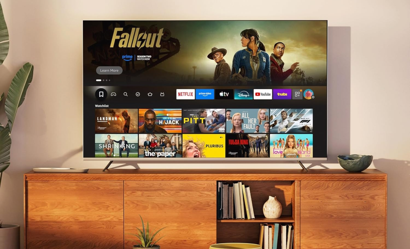 Toshiba 75-inch Z670 Series Mini-LED 4K UHD Smart Fire TV sitting on a TV stand.