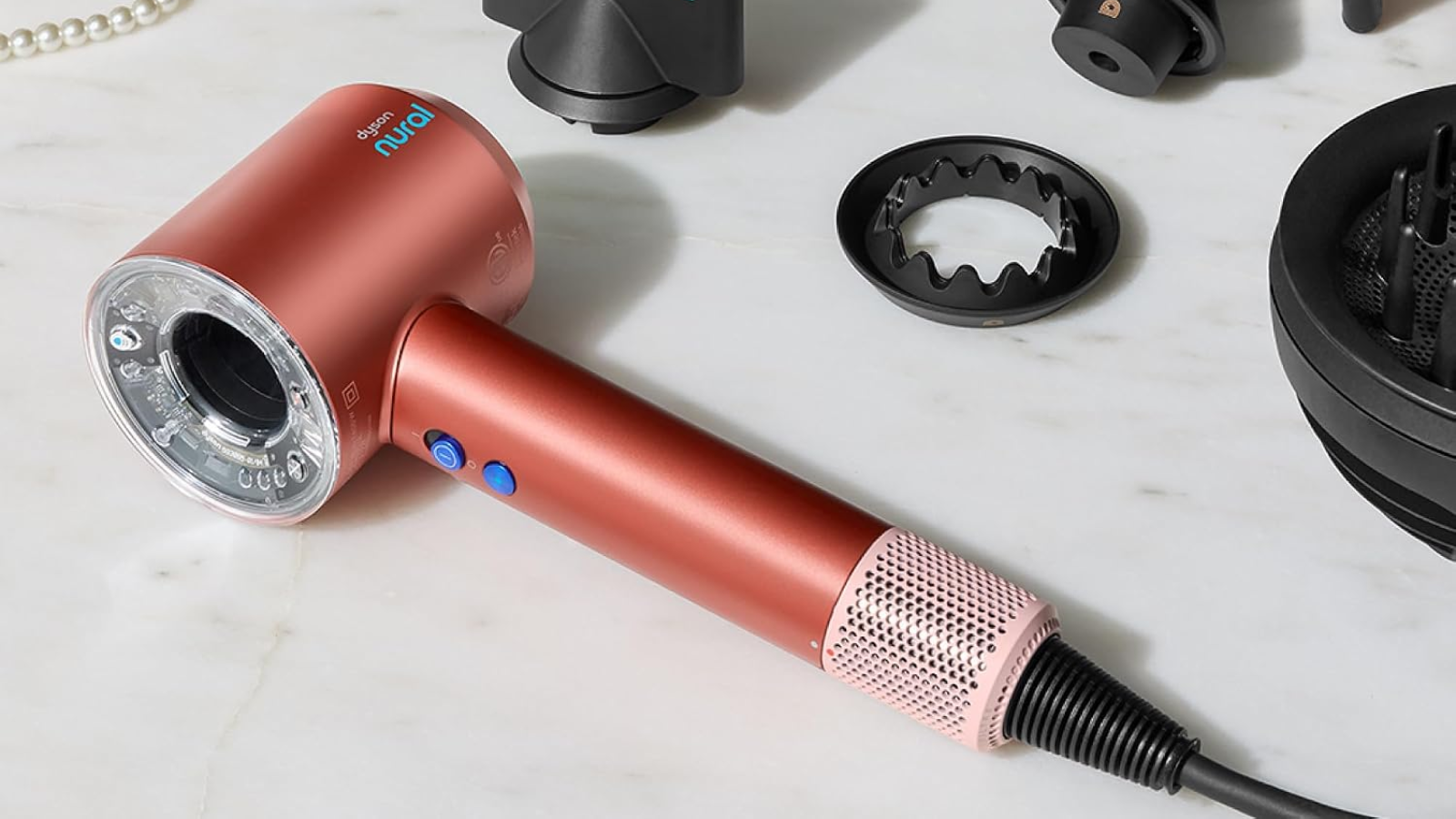 a dyson supersonic nural hair dryer on a stone countertop