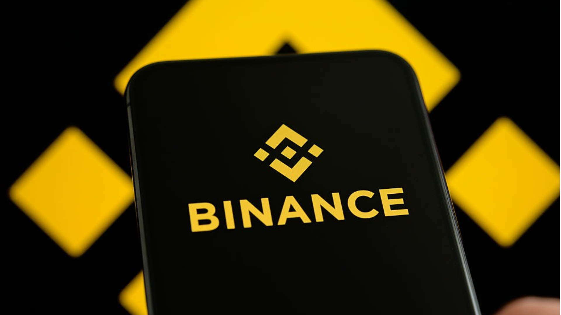 The Binance logo on a smartphone.