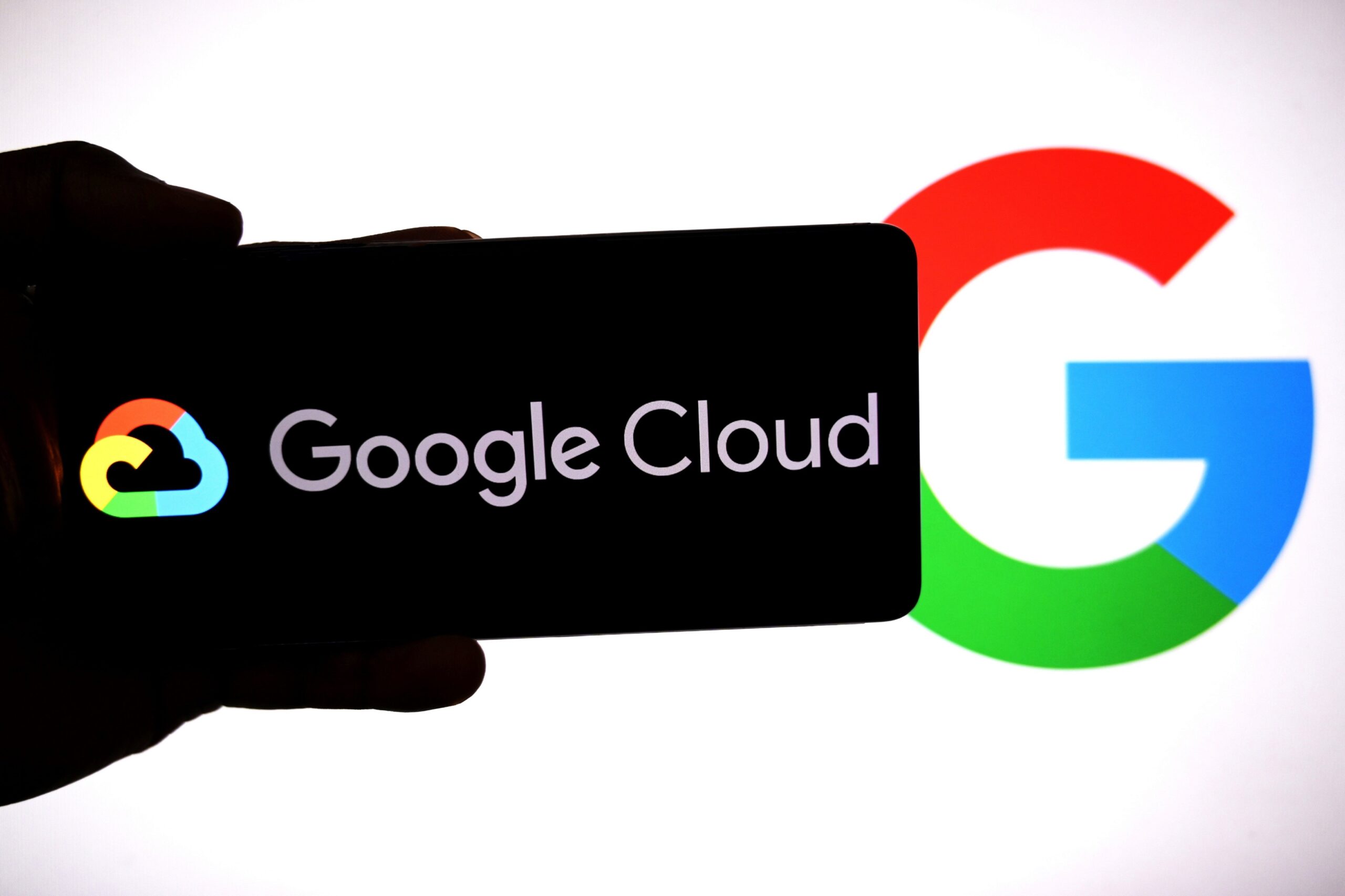 The Google Cloud logo is visible on a smartphone screen.