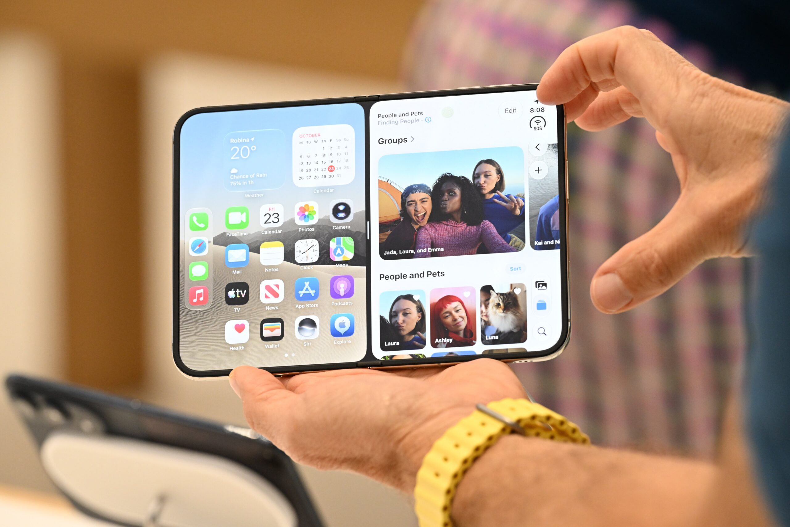 Apple Store staff show the new iPhone Duo to customers