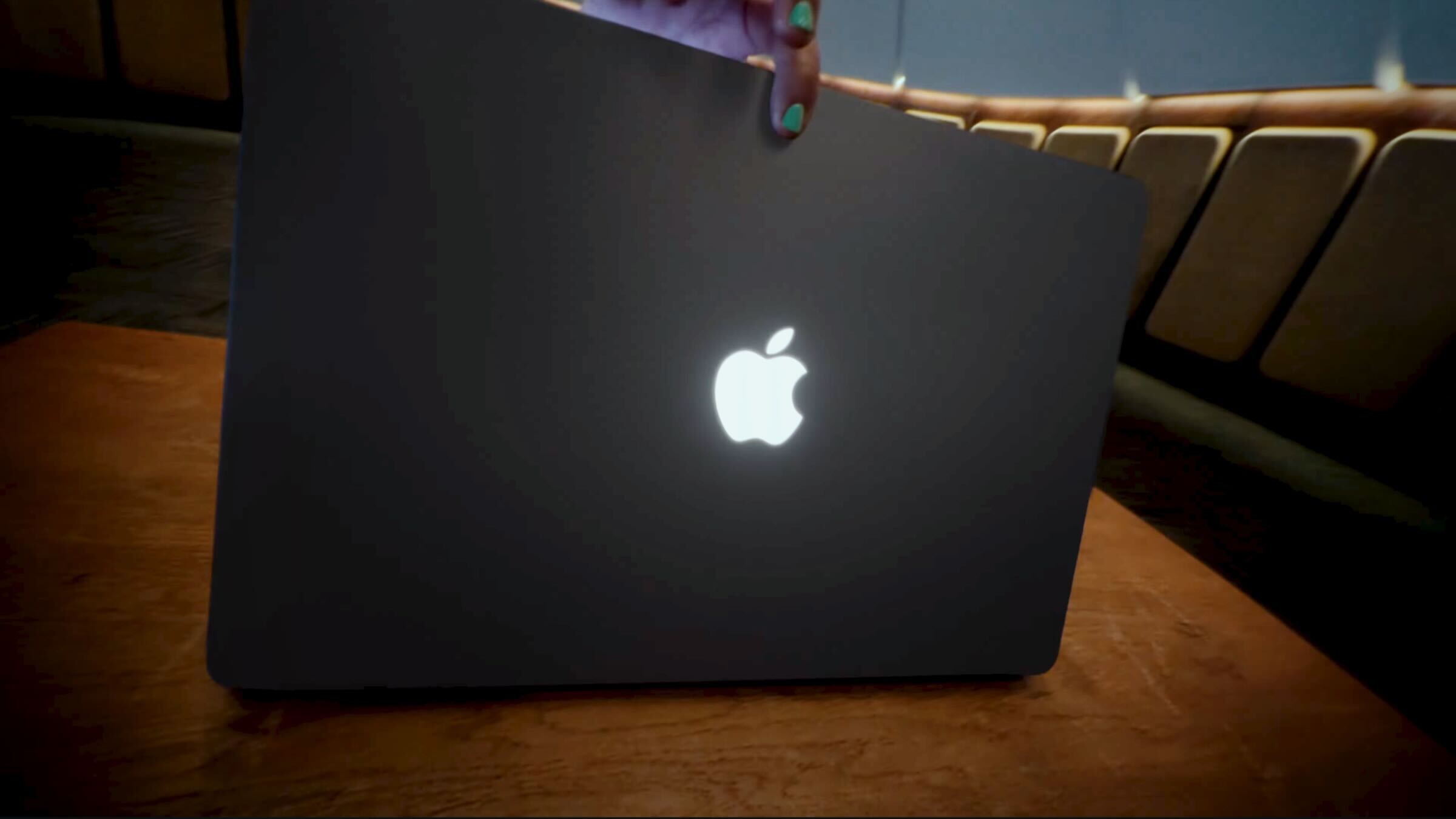 apple macbook pro with glowing apple logo on rear of device