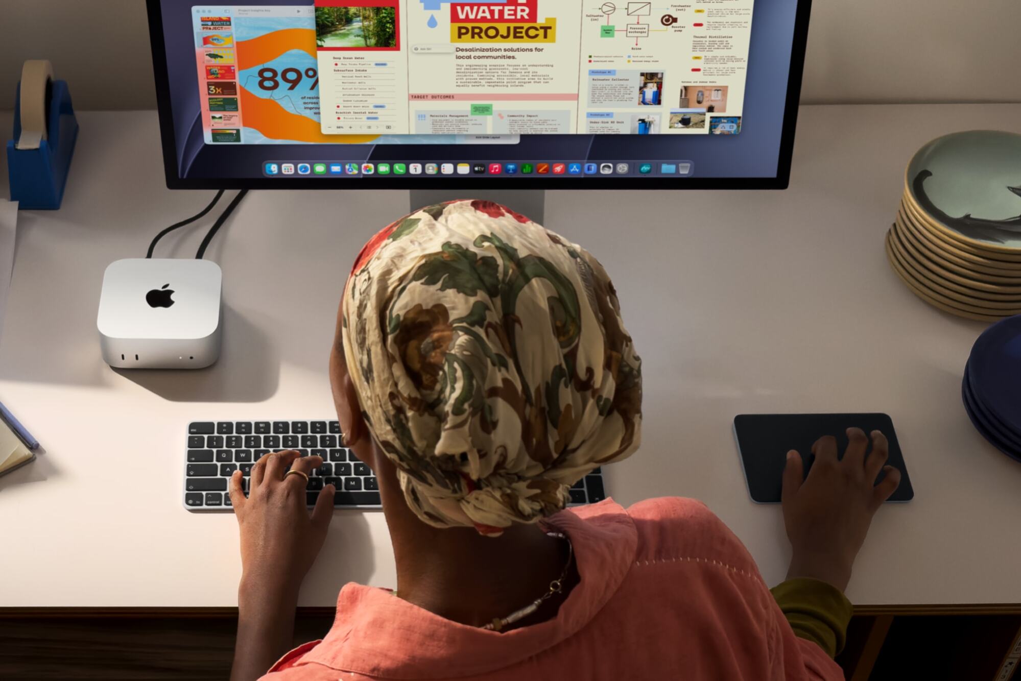 a person using a mac mini hooked up to a monitor