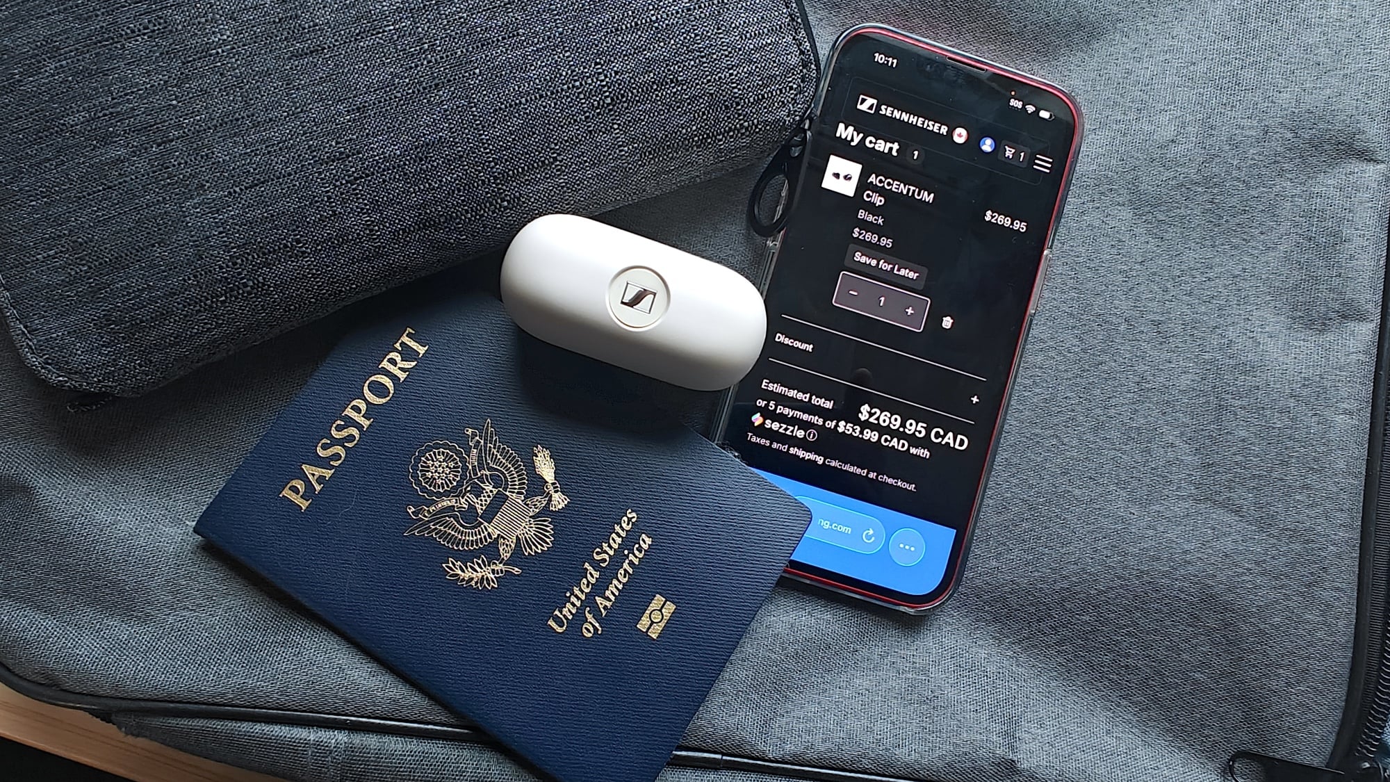 Sennheiser Accentum Clip open earbuds with passport and iphone showing Sennheiser canadian store